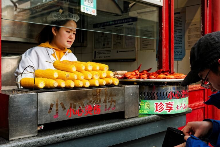 A woman standing in front of a food stand